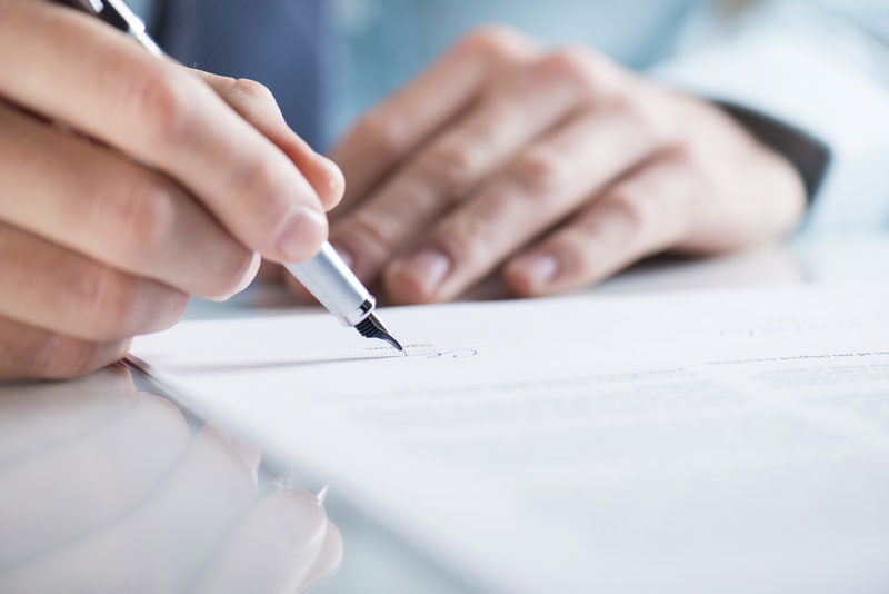 Photo of papers being signed